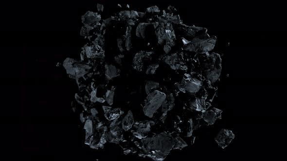 Super Slow Motion Shot of Rotating Exploded Scattered Coal on Black at 1000Fps