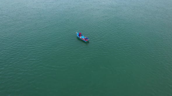 Fishing boat sailing in the sea near river mouth