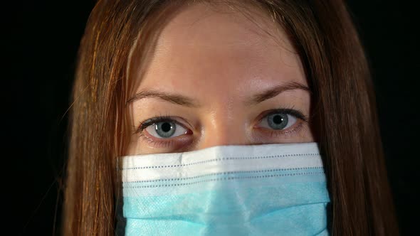 Close Up of Doctor's Eyes in a Mask. Serious Look of a Nurse During Pandemic.