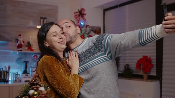 Festive Couple Taking Pictures on Smartphone Feeling Cheerful