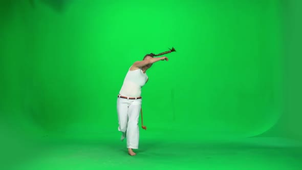 Woman with Long Hair Practicing Capoeira on Chroma Key Studio. Slow Motion.