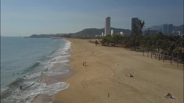 Wide Sand Beach Washed By Ocean and Couple Aerial View