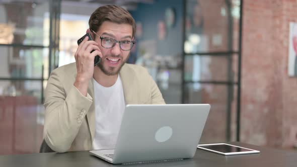 Aggressive Man with Laptop Getting Angry on Phone Call