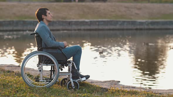 Man in a Wheelchair Near the Lake