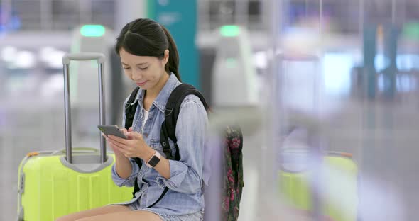 Woman use of mobile phone in the airport