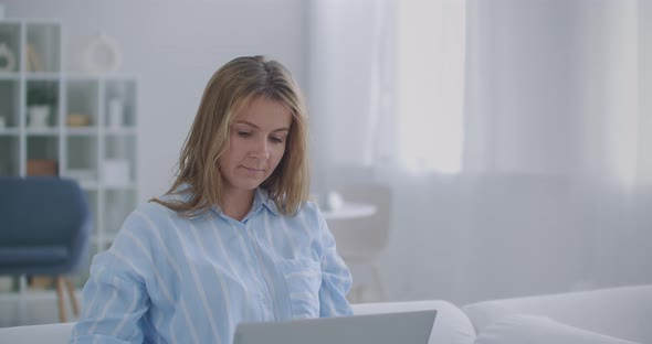 Focused Business Woman Entrepreneur Typing on Laptop Doing Research. Young Female Professional Using