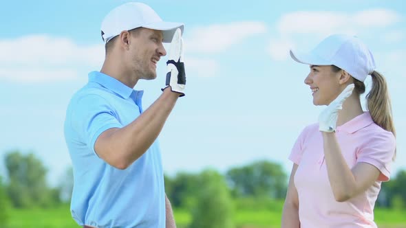 Professional Golf Players Giving High Five to Each Other After End of Tournament