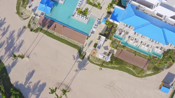 Aerial top down shot of luxury Hotel Resort with pools,palm trees and private beach - Sensatori cap