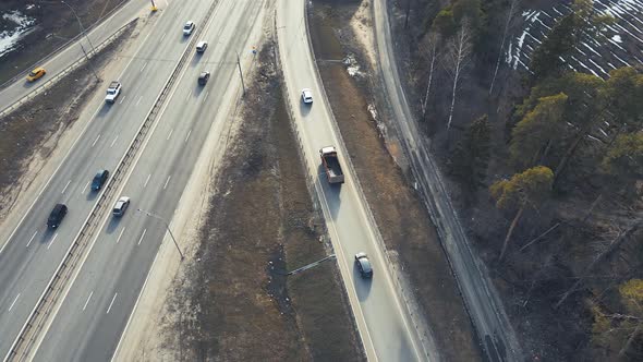 Automobile Highway with a Roundabout of Vehicles View From a Drone