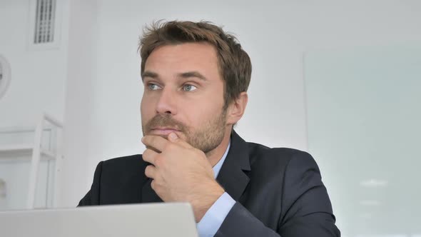 Close Up of Pensive Businessman Thinking at Work