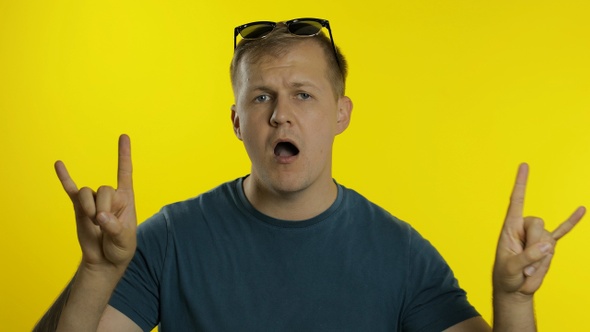 Portrait of Young Caucasian Man Posing in Green T-shirt. Happy Handsome Guy Celebrates and Dances