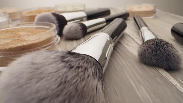 Cosmetic Powder and Brushes on the Wooden Table, Dolly Shoot