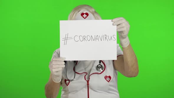 Elderly Female Doctor in Medical Mask Show Page with Message. Coronavirus