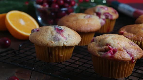 Homemade cranberry orange muffins on cooling rack, Christmas decoration on background, dolly shot