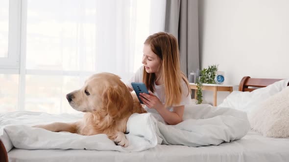 Girl with Golden Retriever Dog and Smartphone