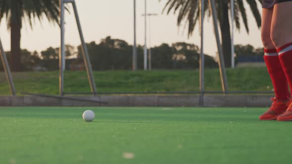 Female hockey players playing on the field