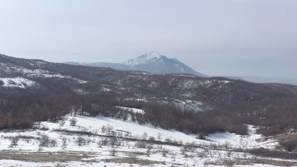 Snow over the top of Rtanj mountain 4K aerial video