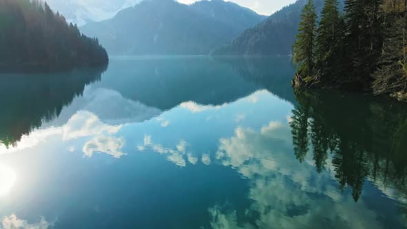 Clear Blue Mountain Lake with Reflection of Clouds on the Water