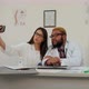 African American Doctor and Pretty Nurse Taking Silly Selfies on the Phone - VideoHive Item for Sale
