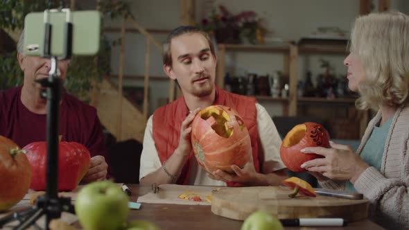 A Young Man with His Parents Talking to the Camera How to Carve Halloween Pumpkins