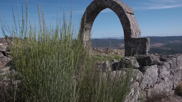 Ancient arch construction on Monsanto mountain and panoramic view of surrounding valley, Portugal. H