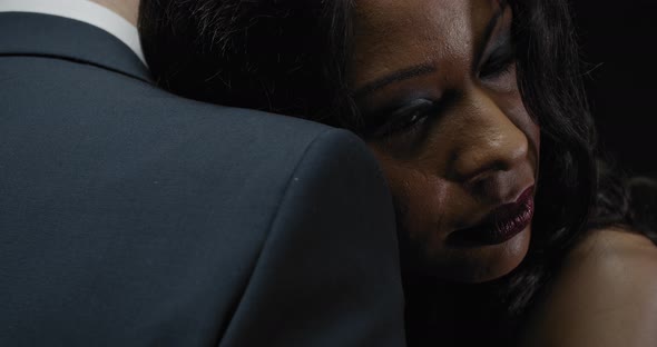 Close Up of a Beautiful Black Woman Smiling While Hugging a Man