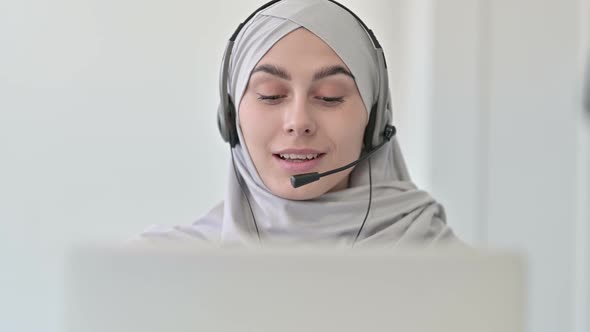 Arab Woman with Laptop Talking on Headset