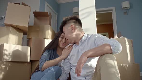 Loving Couple Sitting on Floor on New House