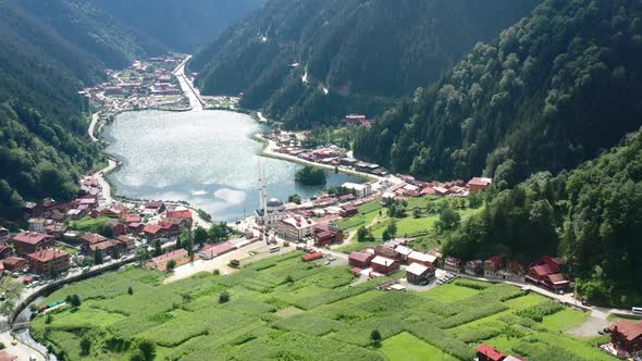 aerial drone of a mosque in Uzungol Trabzon next to a lake on a sunny summer day as the light reflec