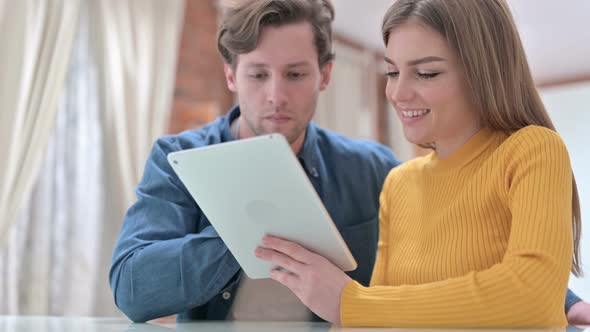 Attractive Office Colleagues Using Tablet in Modern Bedroom 