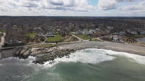 Static drone view of waves crashing upon the shores of a black rock and sand beach. Black Rock Beach