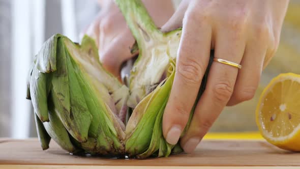 Woman Cut Artichokes. Cooking Process