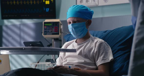 Boy in Mask Making Video Call From Oncology Hospital