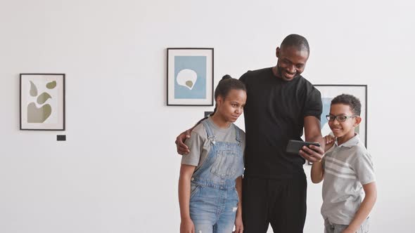 Family Taking Selfie in Art Gallery