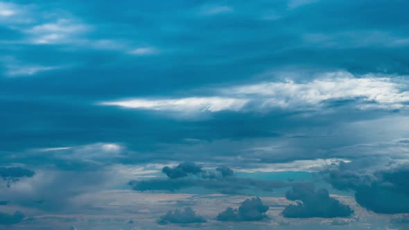 White Fluffy Clouds Slowly Float Through the Blue Daytime Sky Timelapse