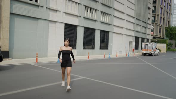 A Girl is Crossing the Street in Front of Her Office