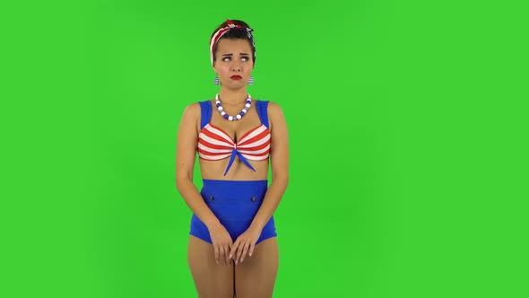 Beautiful Girl in a Swimsuit Is Very Offended and Looking Away . Green Screen