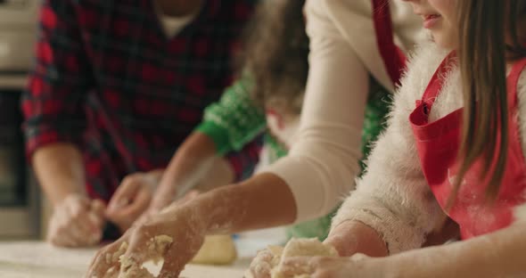 Tilt down view of family making cookies together for Christmas