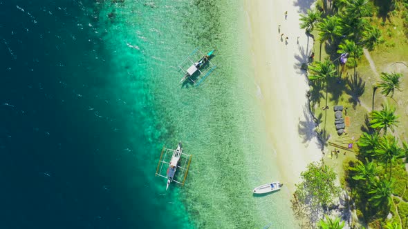 Boats Moored at Paradise Tropical Ipil Beach on Pinagbuyutan Island with Azure Turquoise Sea in El