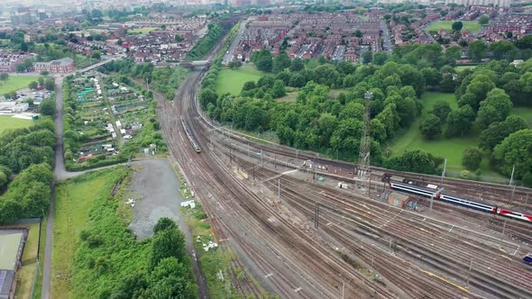 Aerial drone footage of railway depot and railway tracks in the summer time showing lots of trains