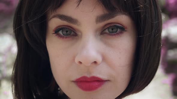 Closeup Face of Caucasian Brunette Woman with Big Eyes and Red Lips Dressed in Japanese Style