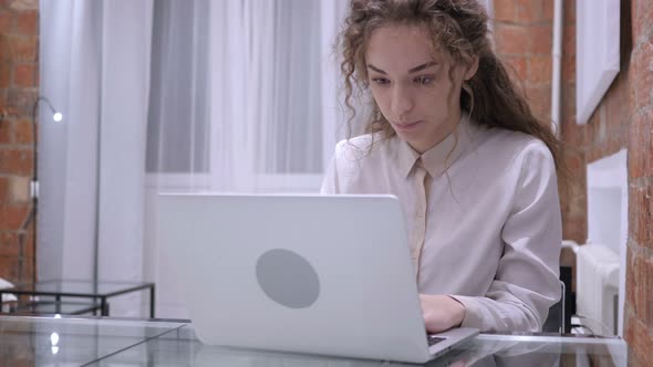 Young Female Working on Laptop at Night