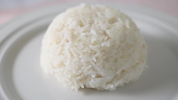 Macro Slow motion of jasmine rice that is cooked and then served on a plate