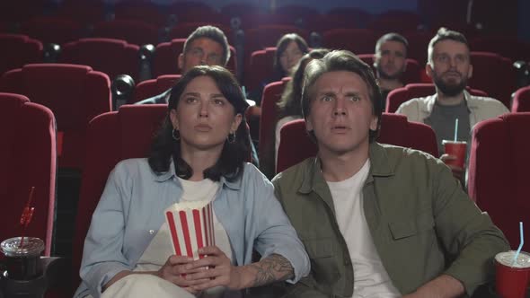 People Watching Horror Movie in the Cinema