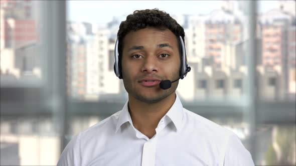 Young Positive Indian Man Works in a Callcenter