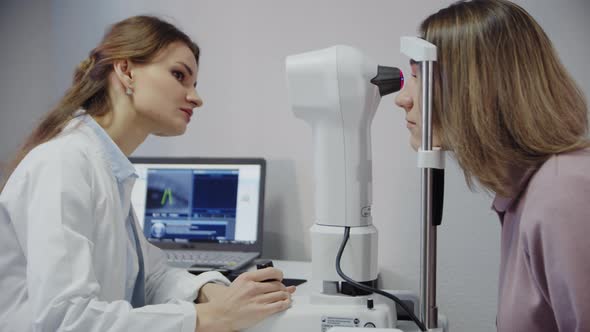 The Ophthalmologist Examines the Patient's Eye and Then Looks Into the Camera