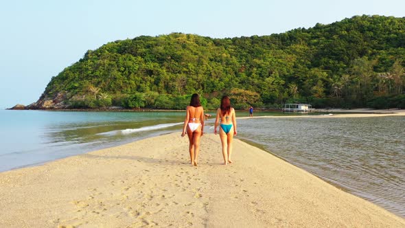 Women tanning on tropical resort beach lifestyle by blue lagoon and white sandy background of Thaila