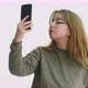 Attractive Woman Makes Selfie with Smartphone in Studio - VideoHive Item for Sale