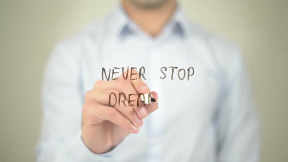 Never Stop Dreaming, Businessman Writing on Transparent Screen