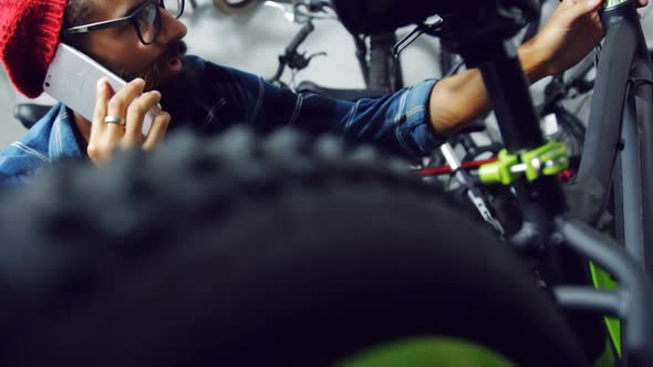 Mechanic talking on mobile phone in workshop